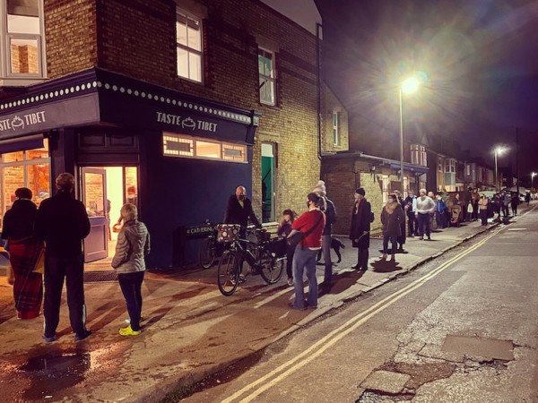 Sometimes we get so stuck in the day-to-day that we can forget where we’ve come from. The writer etain_oc may be right in saying that “there’s a love story worthy of Hollywood behind these scenes”. It’s good to be reminded. If I hadn’t struck up conversation with Yeshi on a mountain path in India, Magdalen Road would be momo-less - can you imagine?Yes - we met in the shadows of the Himalayan foothills. This was the olden days, you know, when talking to strangers was a bit less terrifying. The date is cemented into my brain, but not into Yeshi’s. He’s loose on these things: anniversaries etc. were not traditionally marked in Tibet.

It was November 13th, and it just so happens that 11 years later we opened our restaurant on the same date. We didn’t plan it that way. It was 2020, and all planning had gone out the window months before. Like everyone else during Covid, we were just getting through one day at a time. We spent most of the year doing up our new space while running deliveries to doorsteps and car parks far and wide for a few pennies in between. In the end, we just had to open. And it happened that the timing was good for November 13th, but also that November 13th fell right in the middle of the government’s second lockdown.

No bother: the people came out anyway (pictured). On our first night the queues stretched all the way to the end of the block (these were the days of social distancing, but still!).

In fact, we never wanted to open a restaurant. Taste Tibet started life in 2014 as a market and festival food stall. The nomadic life worked for us and felt familiar. But wherever we pitched up, everyone would always ask, “where is your restaurant?”. It got to the point that we started writing it into our menu board: “WE DON’T HAVE A RESTAURANT”. Eventually, we figured maybe we should just open one.

This Saturday 15th Nov (12-3) we are marking 5 years of momos, laughs and community on Magdalen Road. Weather dependent, we might have dumplings out on the pan: we know you love and miss these from our market days. There will be FREE MOMOS for everyone who follows our journey on Substack. Just hit the link in bio and we’ll send you a unique access code.